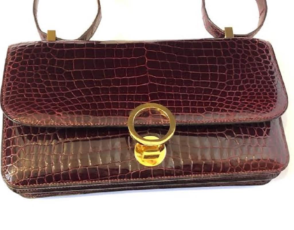 Sold at Auction: A Vintage Hermes Constance Handbag. Burgundy red crocodile  leather. Gilded hardware with letter H clasp. Interior zipped compartment.  In good condition but some slight markings on inner flap. Ref