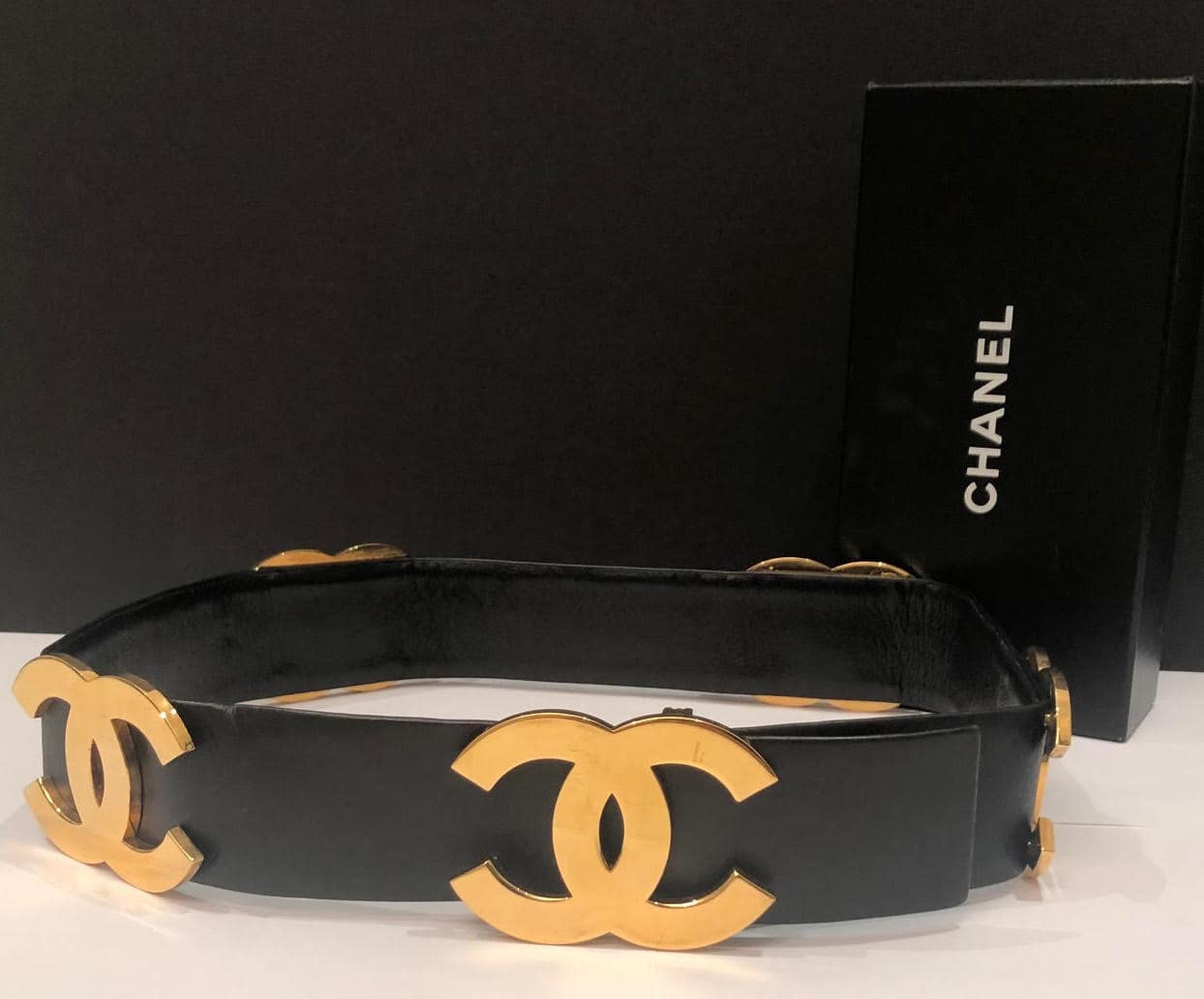 Chanel black quilted caviar leather belt with silver CC logo chain buckle.